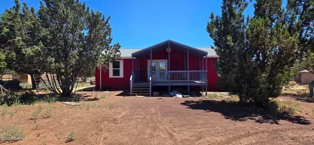 a view of a balcony with wooden floor and furniture
