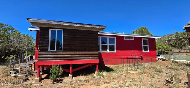 a kitchen with stainless steel appliances granite countertop a sink a stove a refrigerator and island with wooden floor