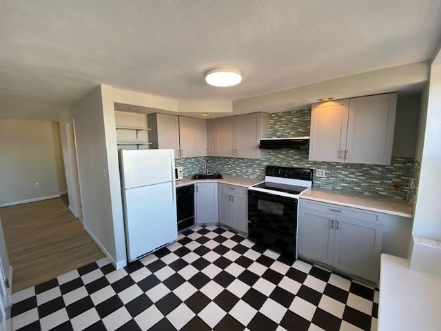 340 Main Street, Unit 501 Melrose, MA 02176 - Photo 7 of 11 a kitchen with a refrigerator and a stove top oven