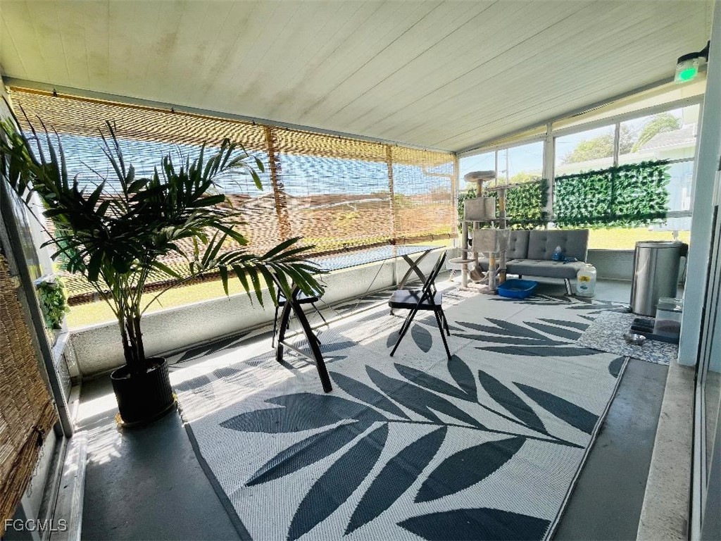2210 Croton Court Lehigh Acres, FL 33936 - Photo 13 of 13 a view of living room with furniture and floor to ceiling window