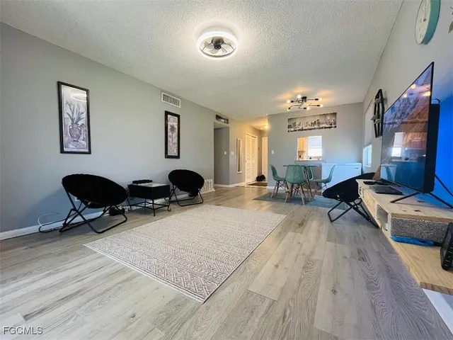a view of a livingroom with workspace and a couch