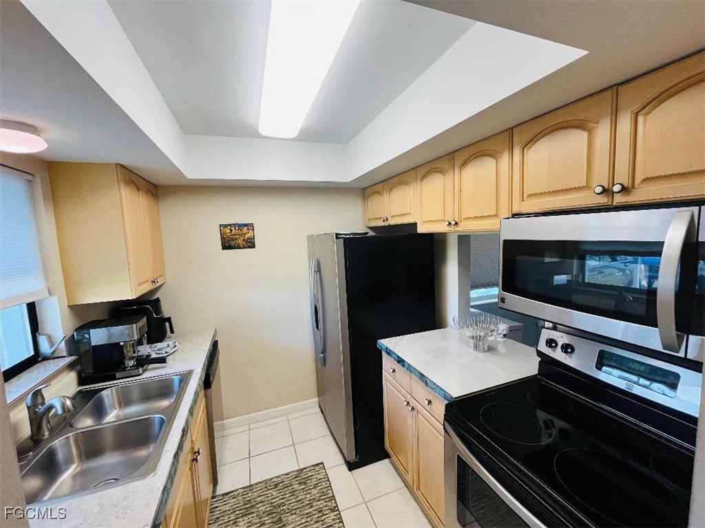 2210 Croton Court Lehigh Acres, FL 33936 - Photo 4 of 13 a kitchen with a refrigerator stove and microwave