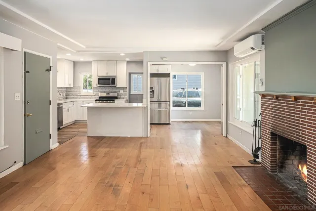 a kitchen with granite countertop white cabinets and stainless steel appliances