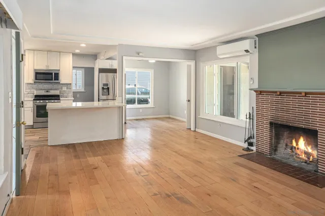 a kitchen with a sink stove a refrigerator and white cabinets