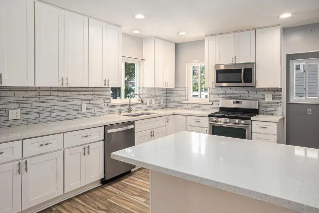 a kitchen with a stove microwave and refrigerator