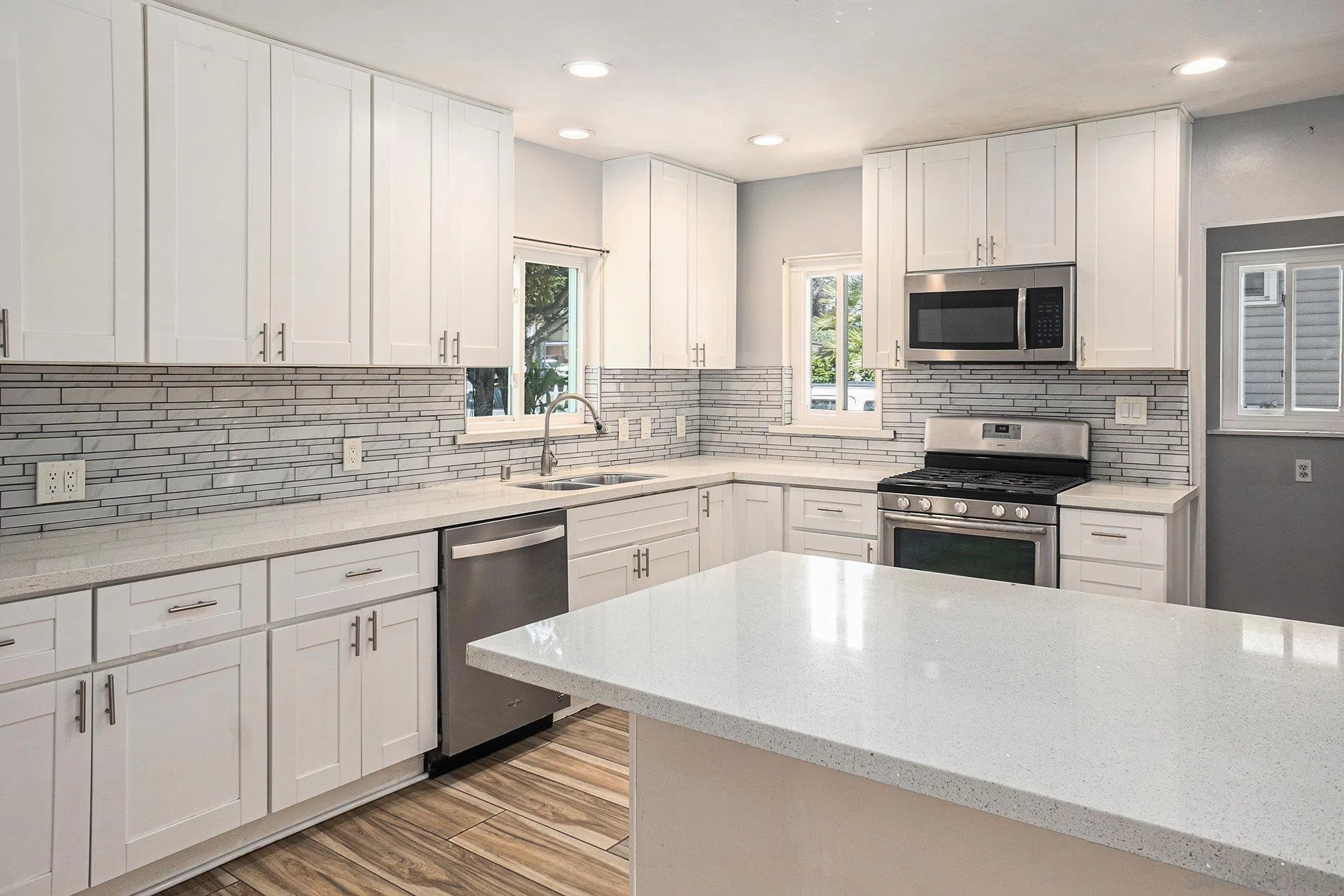 74 E Street Chula Vista, CA 91910 - Photo 37 of 56 a kitchen with granite countertop white cabinets and stainless steel appliances