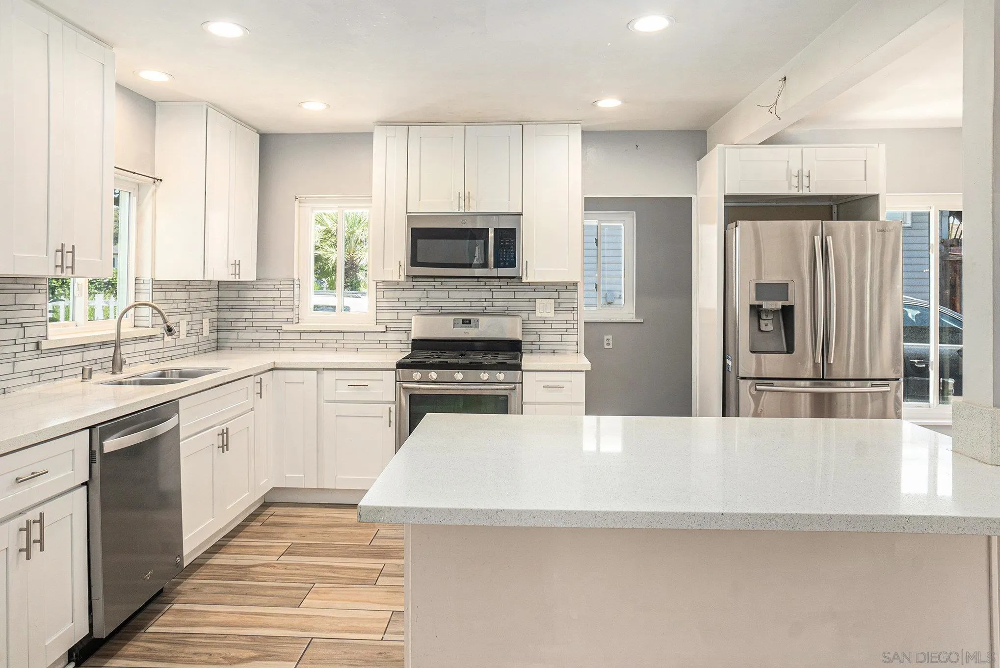 74 E Street Chula Vista, CA 91910 - Photo 40 of 56 a large kitchen with a large window and stainless steel appliances