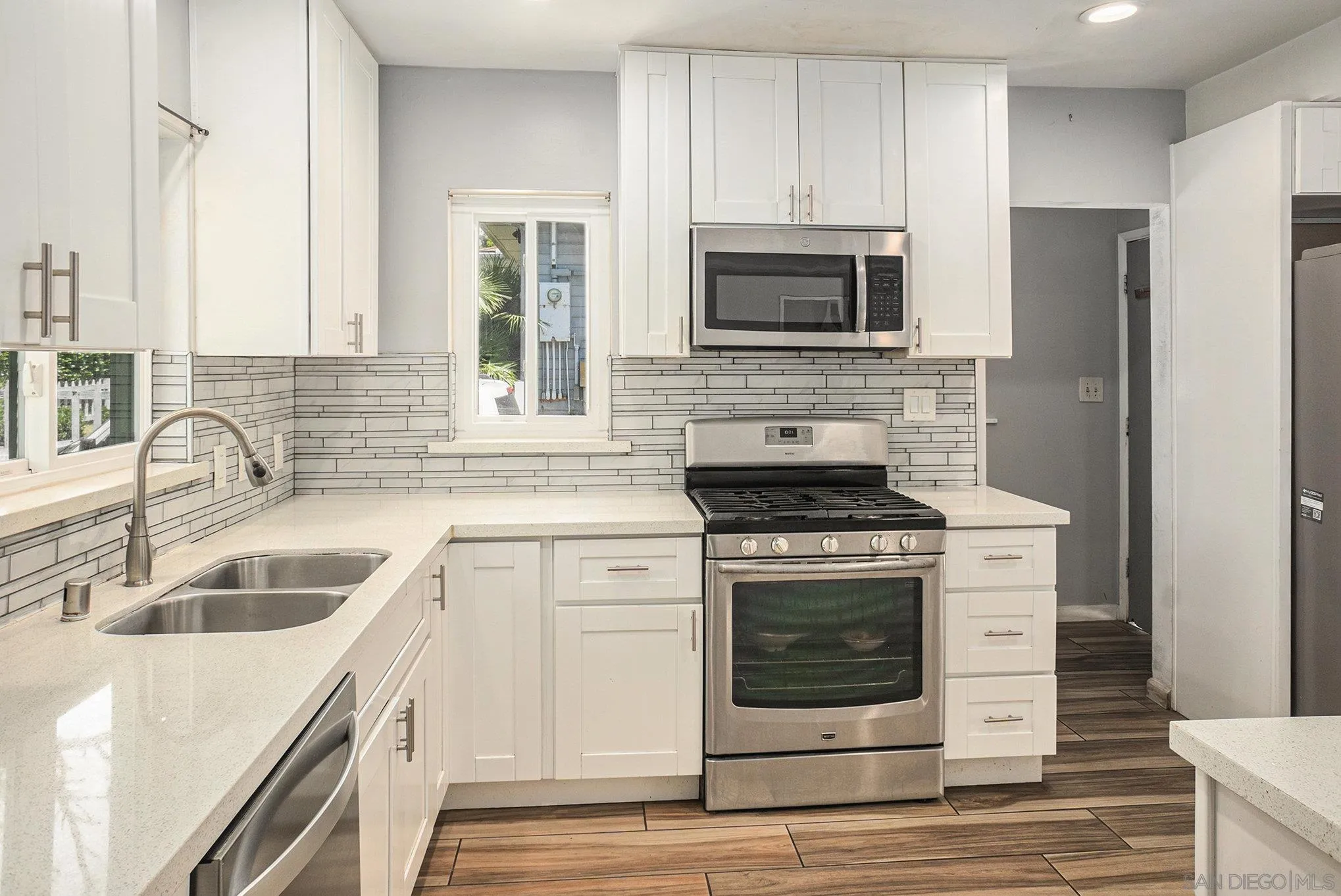 74 E Street Chula Vista, CA 91910 - Photo 41 of 56 a kitchen with a stove microwave and refrigerator