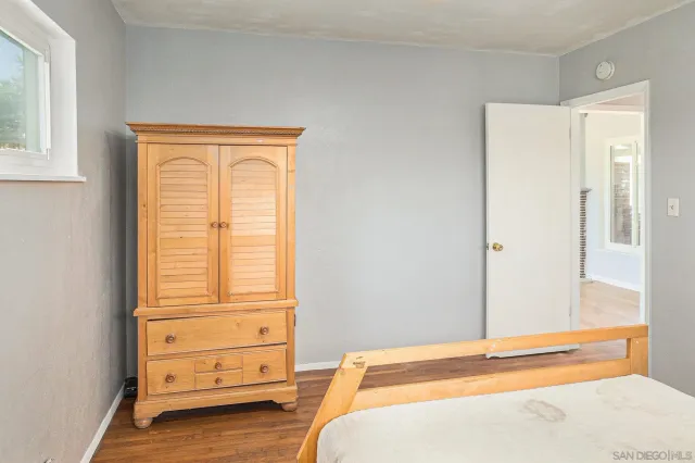 a view of a workspace room with wooden floor and chair