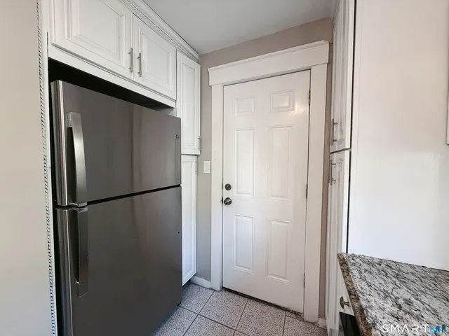 a view of a kitchen with refrigerator and cabinet