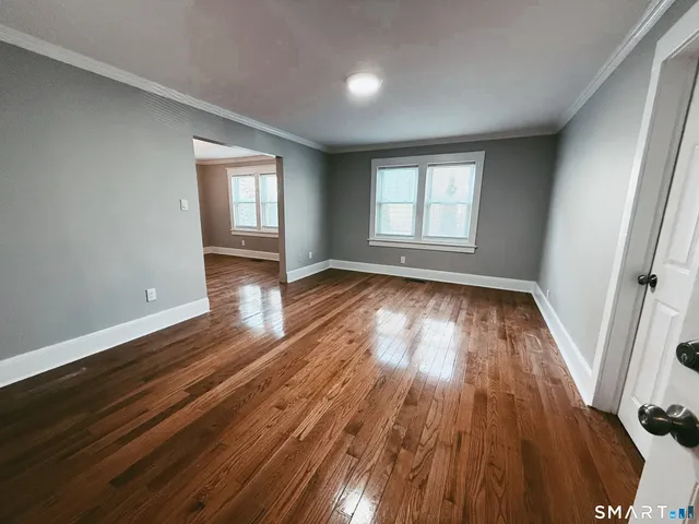 wooden floor in an empty room with a window