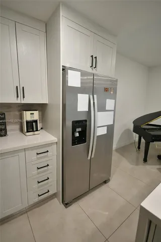a kitchen with cabinets and a refrigerator