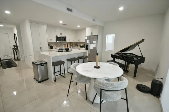 a view of a kitchen with a dining table and chairs