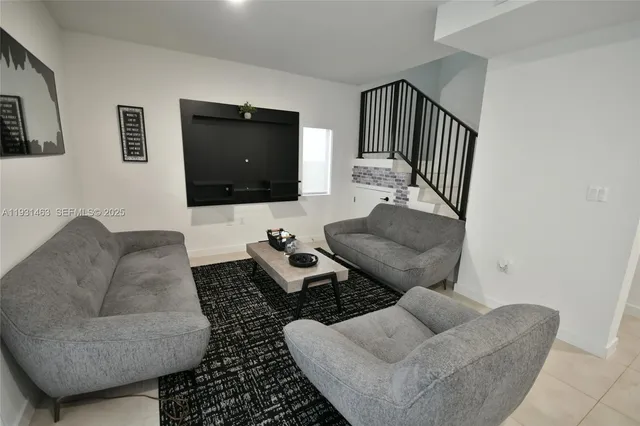 a living room with furniture and a flat screen tv