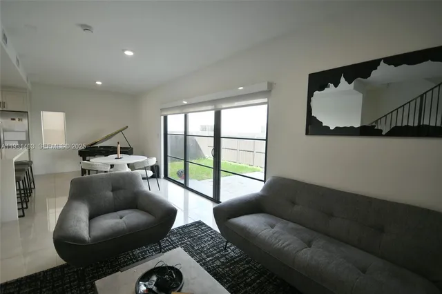 a living room with furniture and a large window