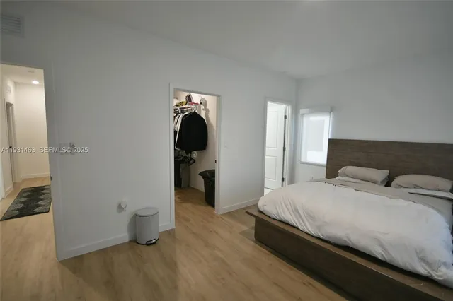 a bedroom with a bed and a view of bathroom