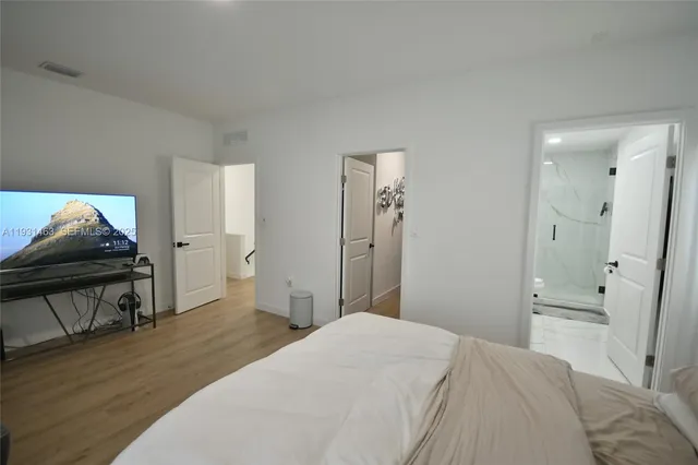 a bedroom with a bed and a chair