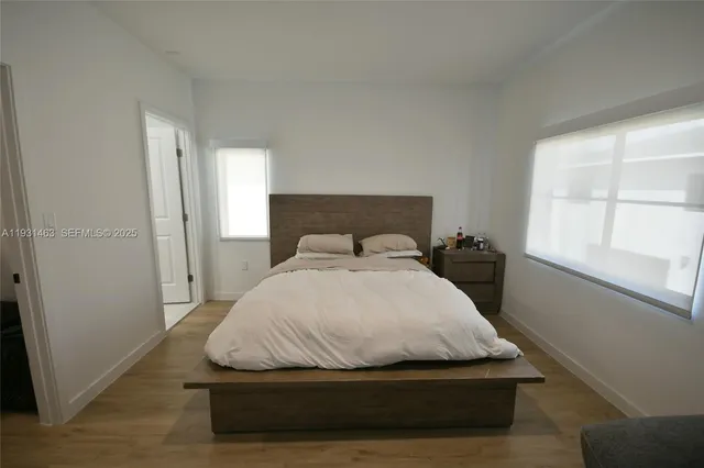 a bedroom with a bed and window