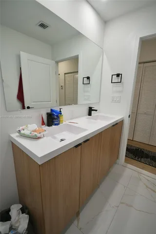 a bathroom with a sink and a mirror