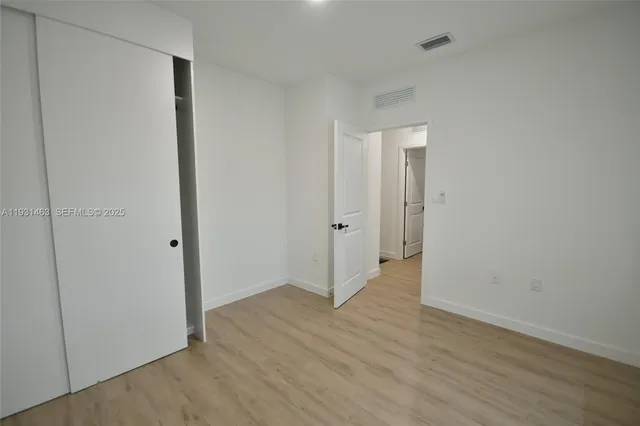 a view of hallway with wooden floor