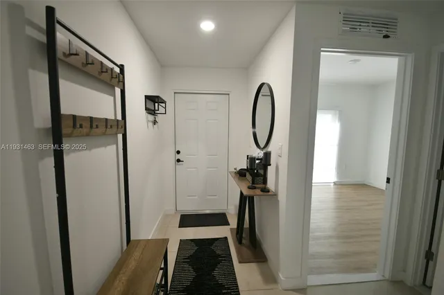 a view of a bathroom from a corridor