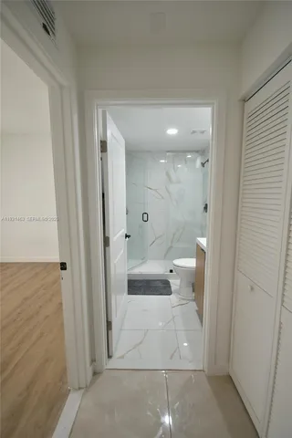 a bathroom with a glass door shower