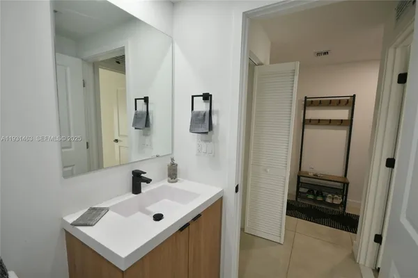 a bathroom with a sink mirror and vanity