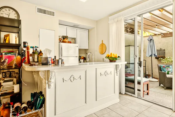 a kitchen with a sink dishwasher and a stove with wooden floor