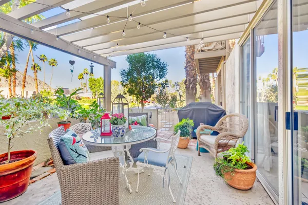 a kitchen with stainless steel appliances granite countertop a refrigerator a stove and a sink with white cabinets