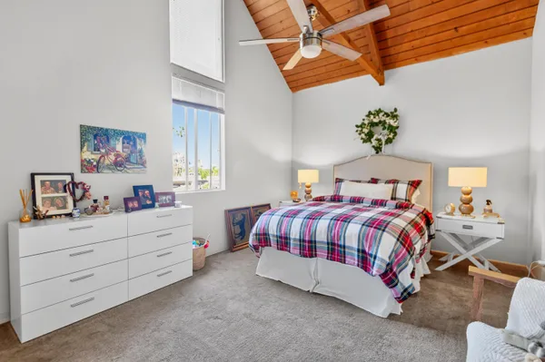 a bedroom with a bed a dresser and a window