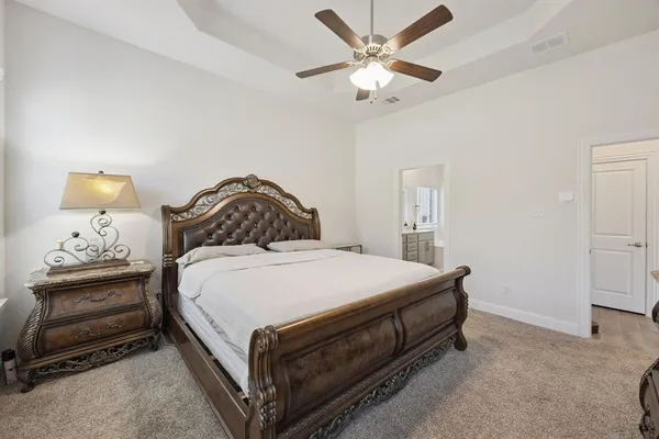 a bedroom with a bed and a chandelier