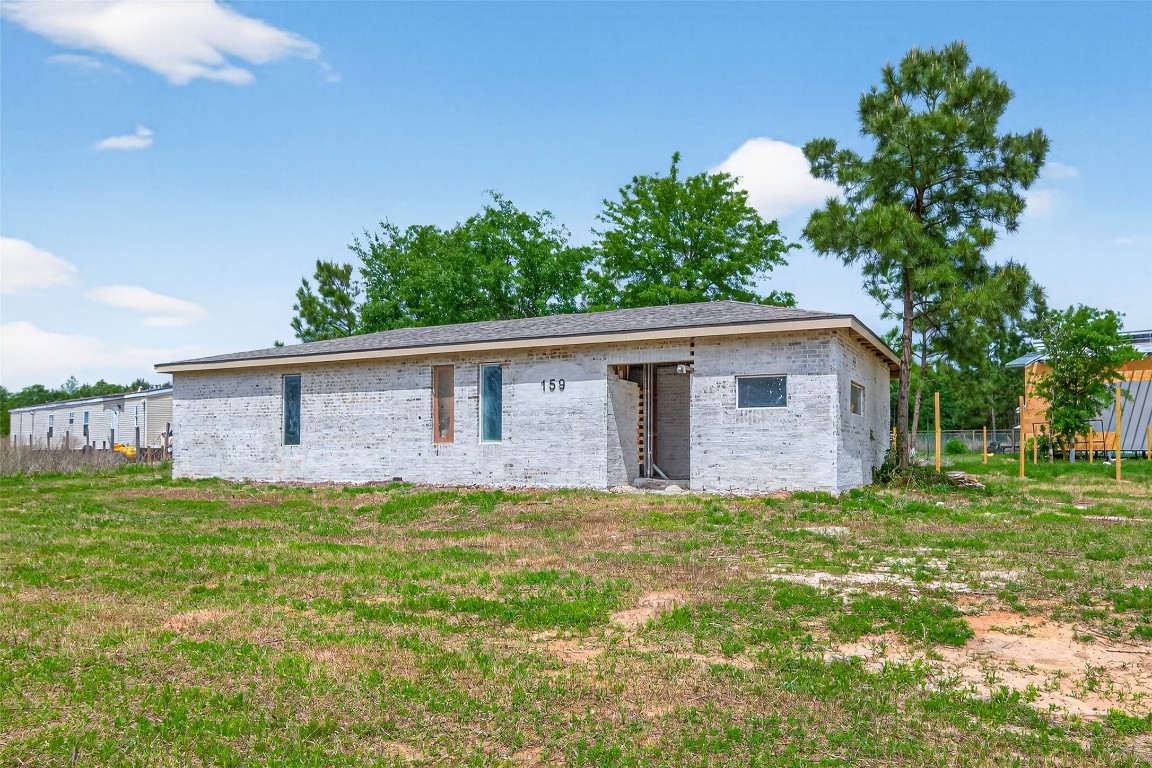 159 Road 5814 Cleveland, TX 77327 - Photo 8 of 12 a view of a house with a yard