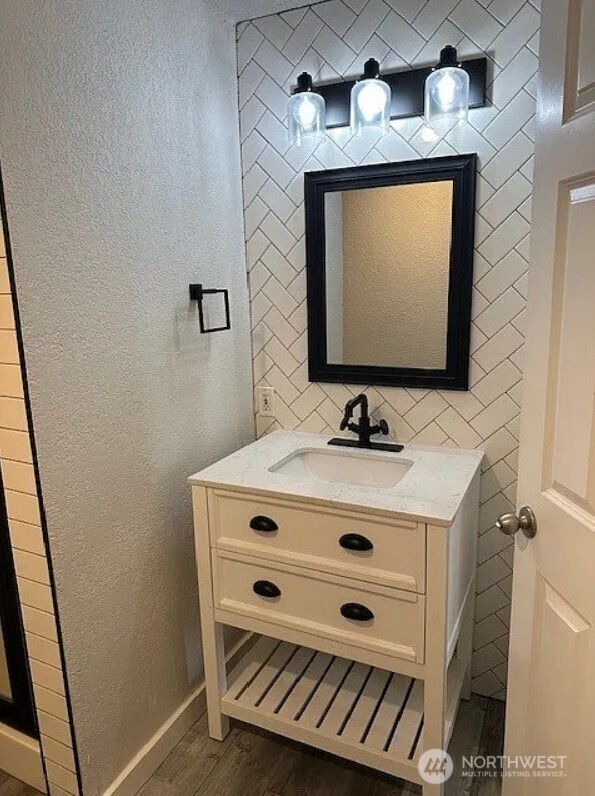 118 4th Avenue Southeast, Unit 118 Puyallup, WA 98372 - Photo 11 of 14 a bathroom with a sink a mirror and a shower