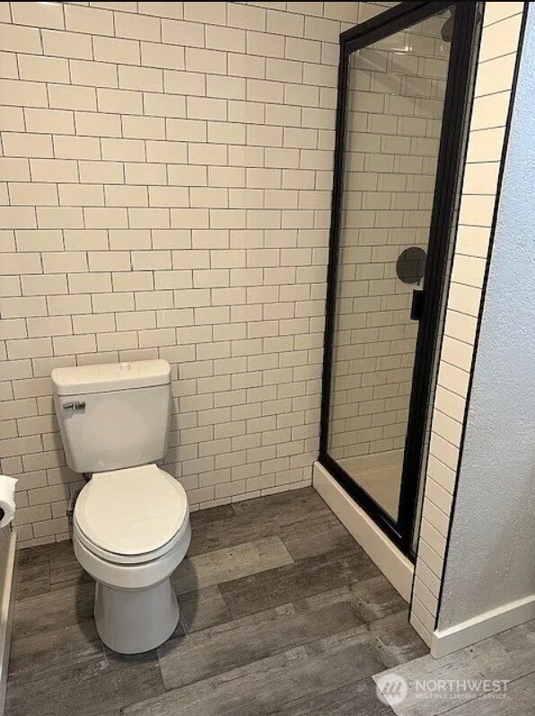 118 4th Avenue Southeast, Unit 118 Puyallup, WA 98372 - Photo 12 of 14 a bathroom with a toilet and a shower