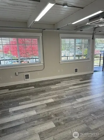 a kitchen with granite countertop a refrigerator and a stove top oven