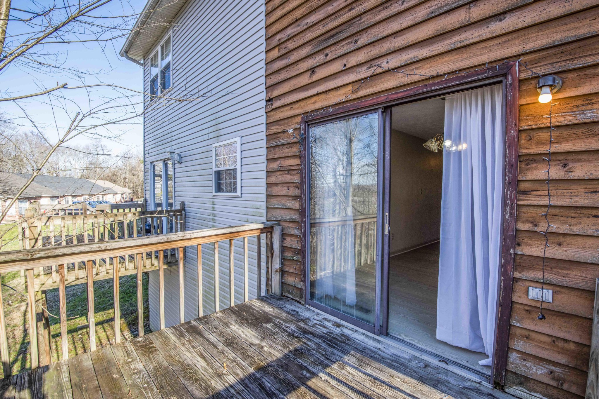 149 High Point Lane Oak Ridge, TN 37830 - Photo 23 of 27 a view of a balcony with wooden floor and fence and a floor to ceiling window
