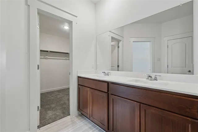a bathroom with a double vanity sink and mirror