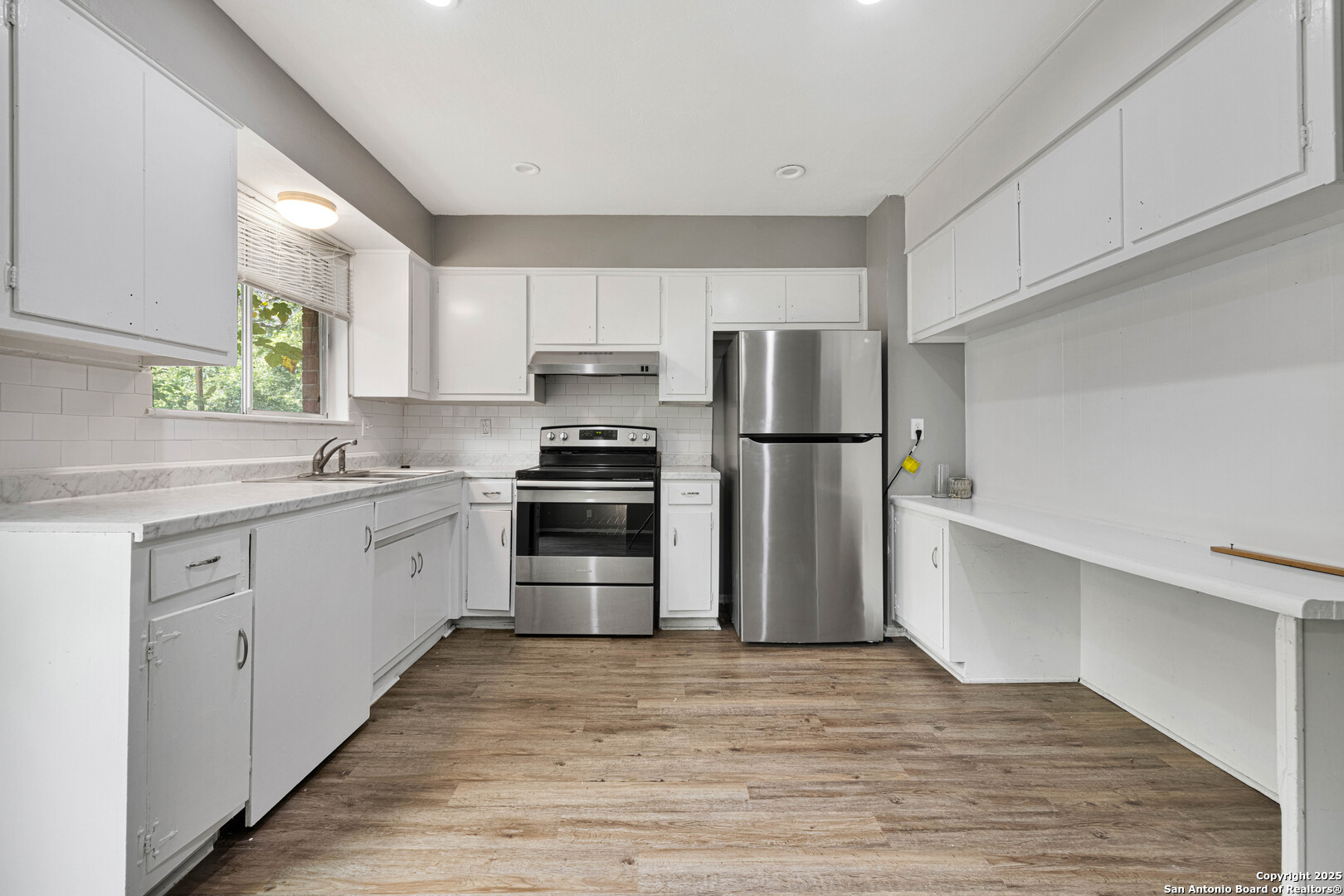 6012 Evers Road Leon Valley, TX 78238 - Photo 13 of 17 a kitchen with a refrigerator and a sink