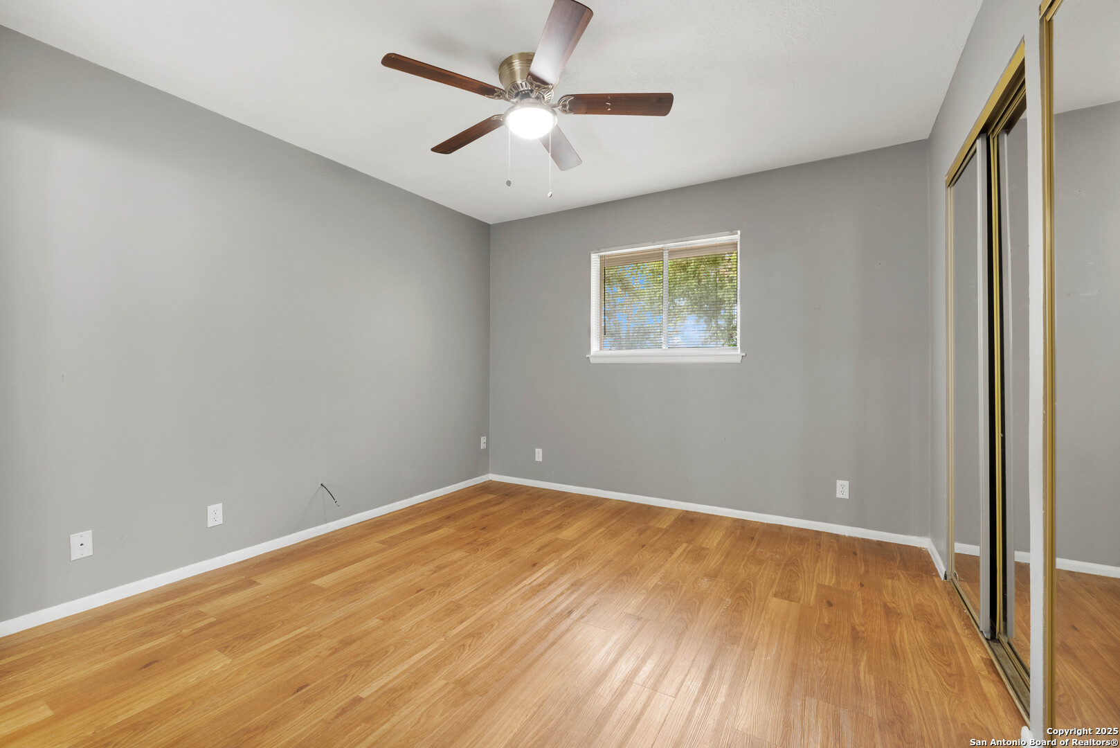 6012 Evers Road Leon Valley, TX 78238 - Photo 6 of 17 an empty room with a window and a ceiling fan
