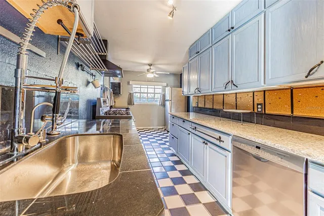 a kitchen with stainless steel appliances granite countertop a sink and cabinets