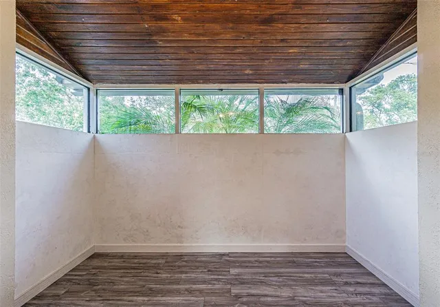a view of room with window and wooden floor