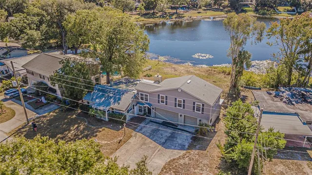 an aerial view of residential house with outdoor space and lake view