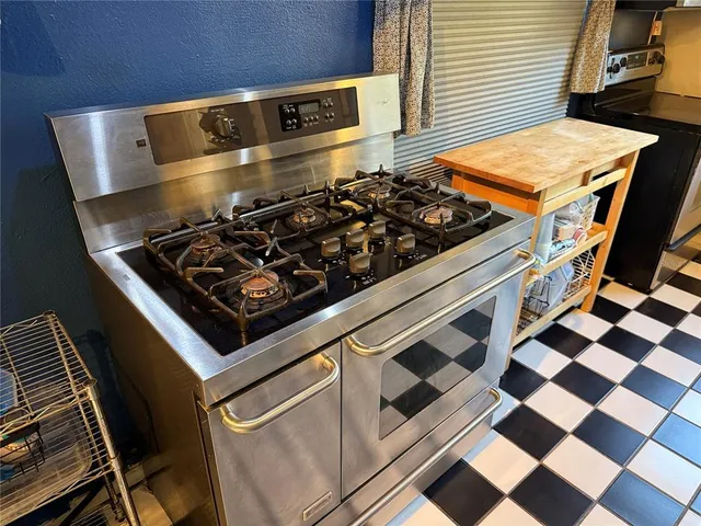a stove top oven sitting inside of a kitchen
