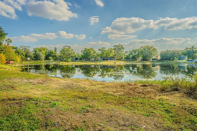 a view of a lake with houses in the back