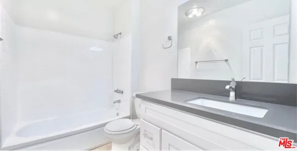 a bathroom with a sink a toilet and a bathtub