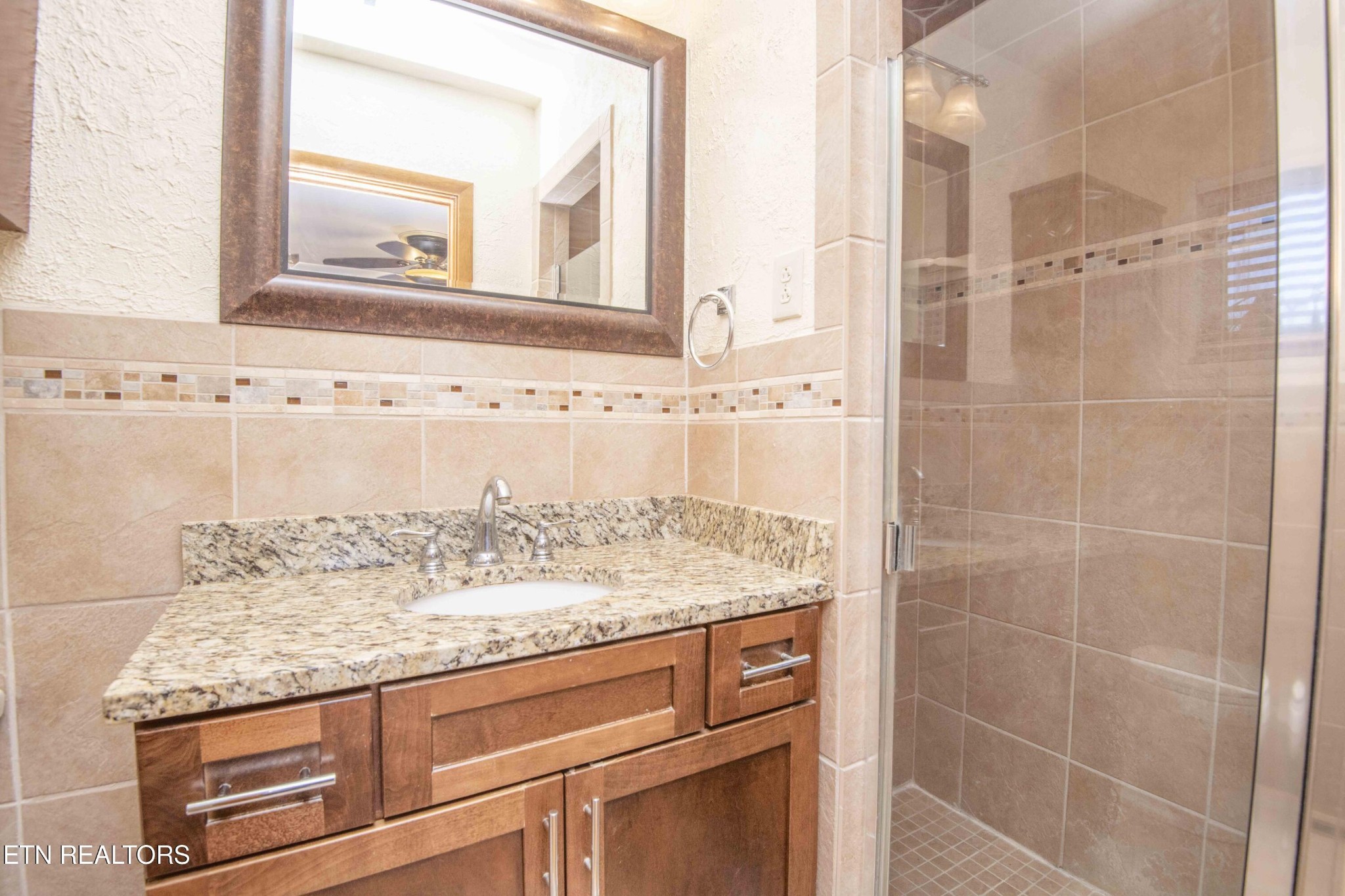 5409 Inwood Road Northwest Knoxville, TN 37921 - Photo 19 of 47 a bathroom with a granite countertop sink and a mirror