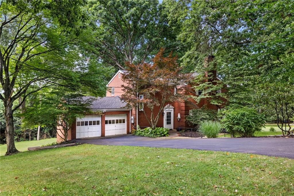 a view of house with a yard