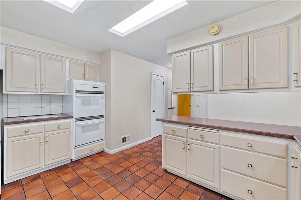 199 Farmington Road Pittsburgh, PA 15215 - Photo 12 of 46 a kitchen with white cabinets and appliances