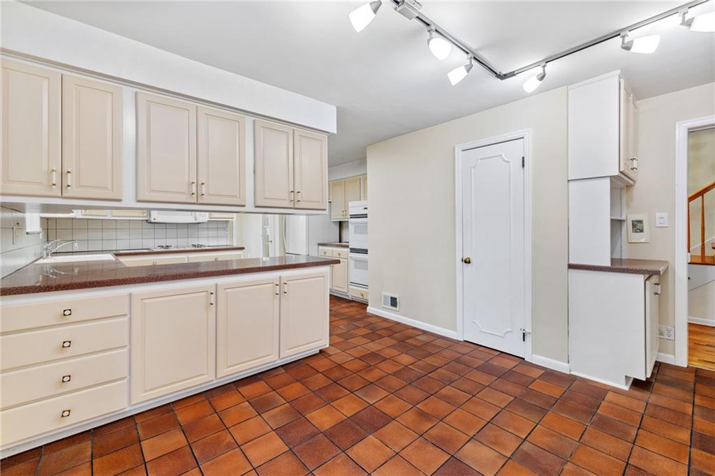 199 Farmington Road Pittsburgh, PA 15215 - Photo 16 of 46 a kitchen with granite countertop white cabinets and stainless steel appliances