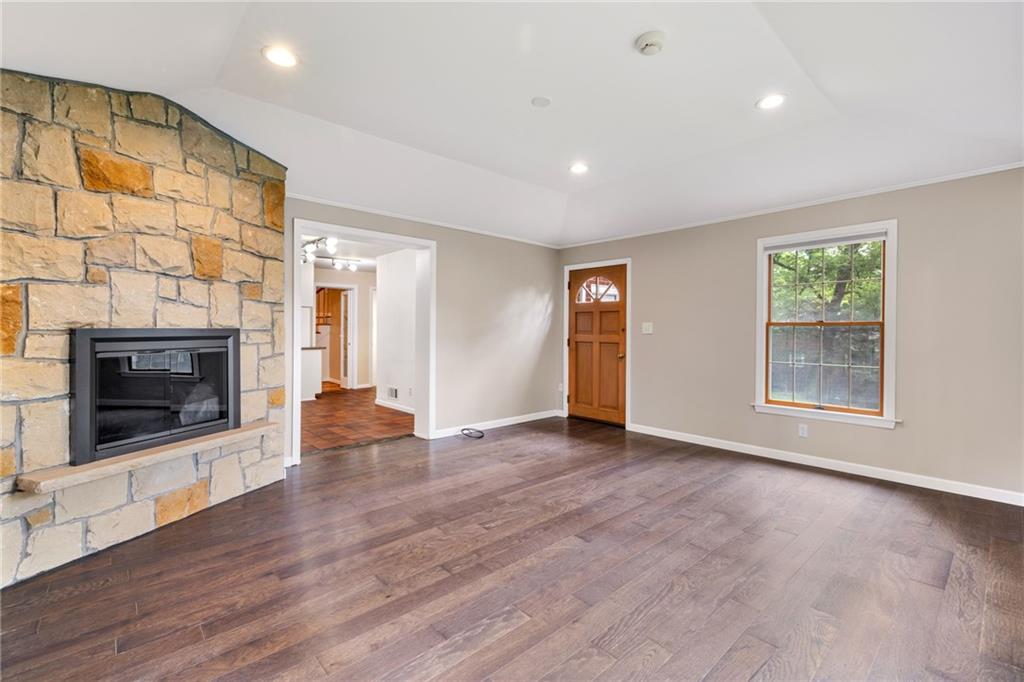 199 Farmington Road Pittsburgh, PA 15215 - Photo 18 of 46 an empty room with wooden floor and a fireplace
